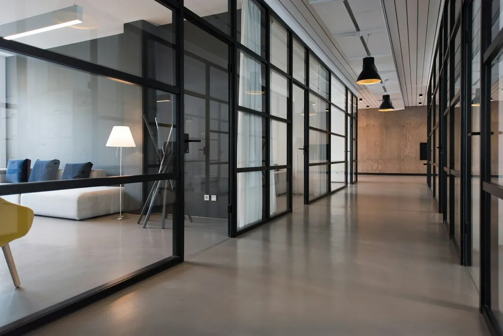 Modern office corridor with glass panel doors and clean bright presentation